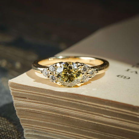 Fancy light yellow diamond ring with trefoil cluster and white diamond side stones in gold