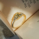 Fancy light yellow diamond ring with trefoil cluster and white diamond side stones