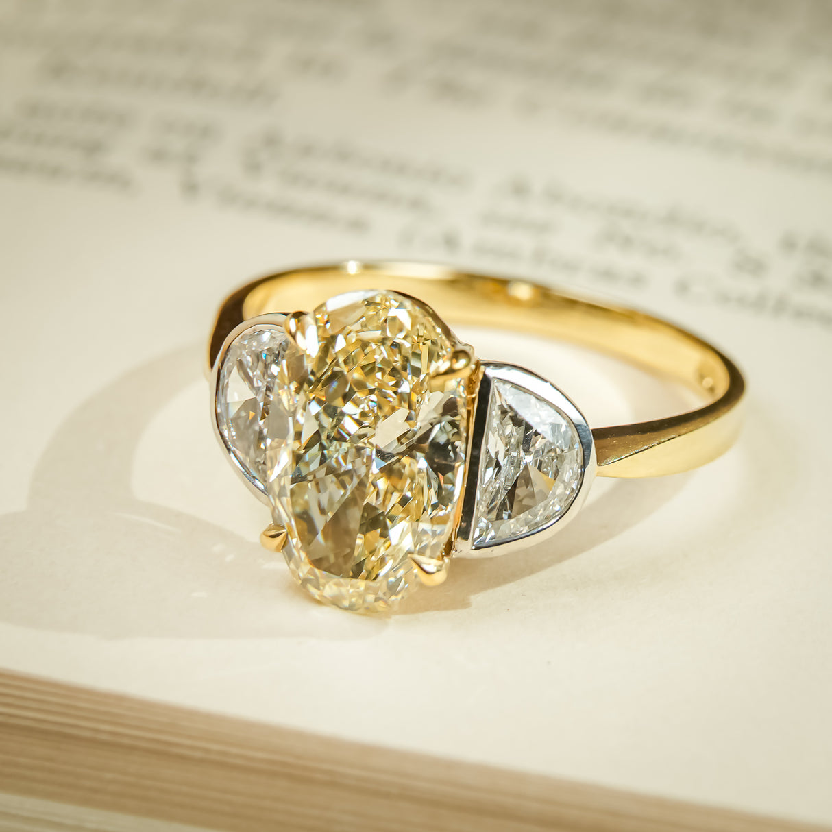 Yellow oval diamond engagement ring with half moon side diamonds