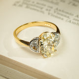 Yellow oval diamond three stone ring with half moon diamond side stones