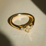yellow pear diamond three stone ring with yellow gold band and side diamonds
