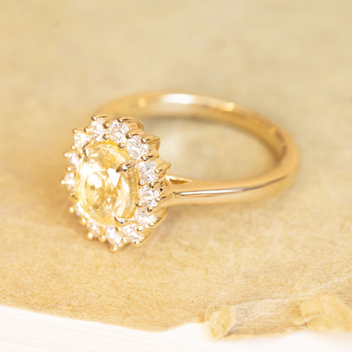 Yellow sapphire and diamond cluster engagement ring in polished yellow gold.