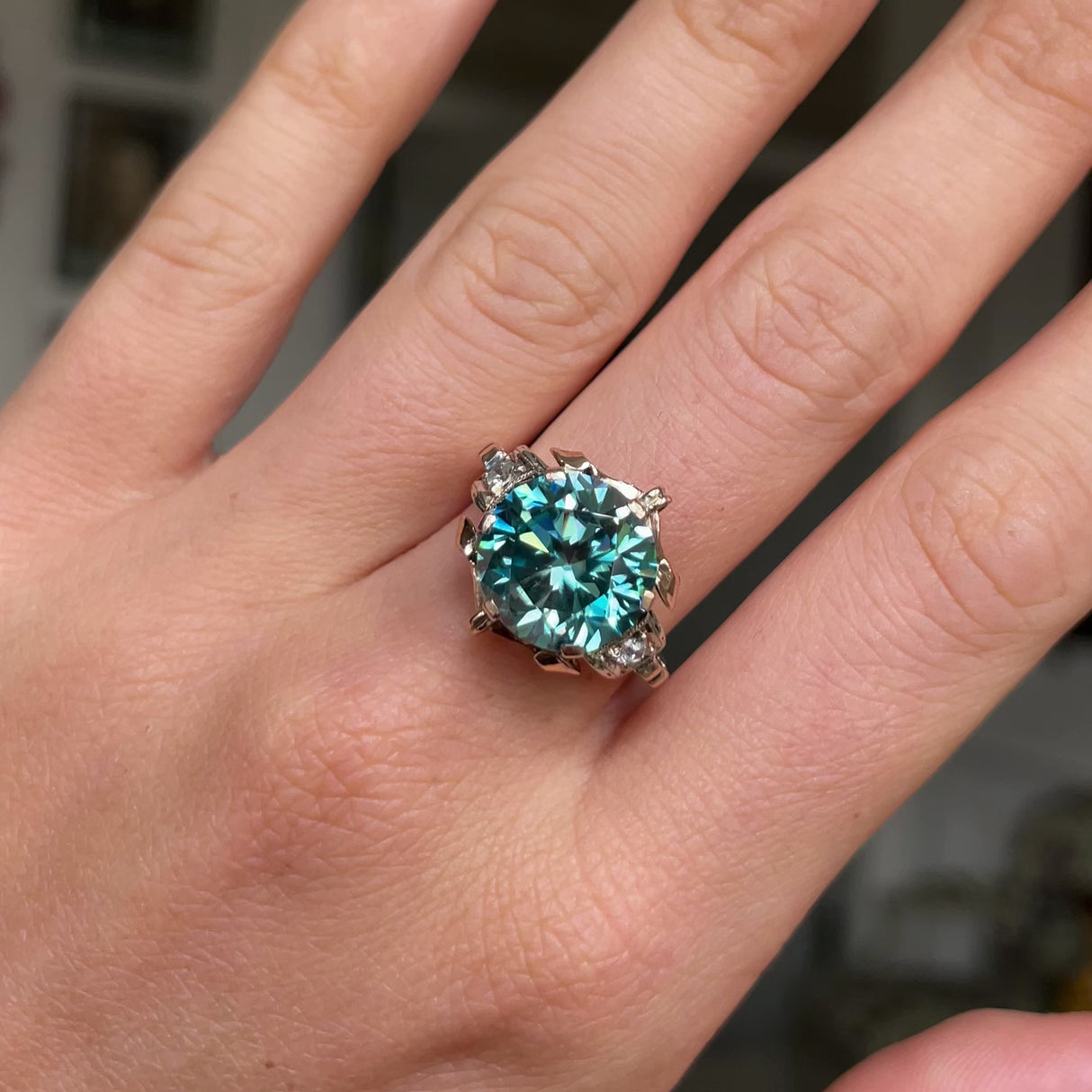 Art Deco zircon and diamond engagement ring, worn on hand and moved around to give perspective.