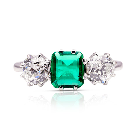 Vintage Art Deco three-stone emerald and diamond engagement ring, front view. 