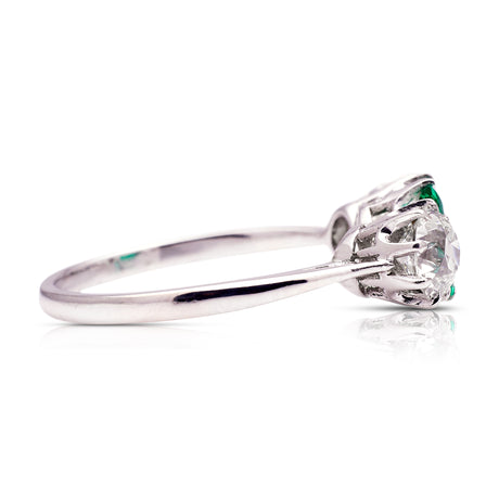 Vintage Art Deco three-stone emerald and diamond engagement ring, side view. 