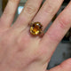 Imperial topaz single stone ring, worn on hand and moved around to give perspective.