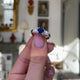 Art Deco three stone sapphire and diamond ring, held in hands and rotated to give perspective.