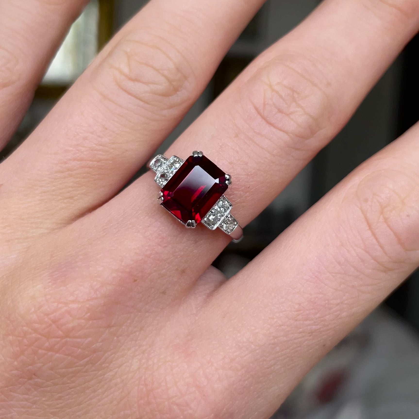 Art Deco garnet and diamond engagement ring, worn on hand and moved around to give perspective.