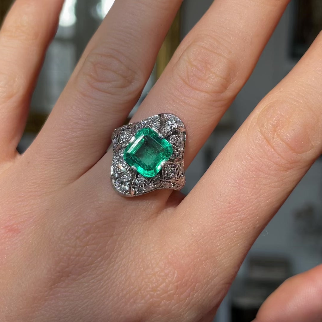 Art Deco emerald and diamond ring, worn on hand and moved around to give perspective.