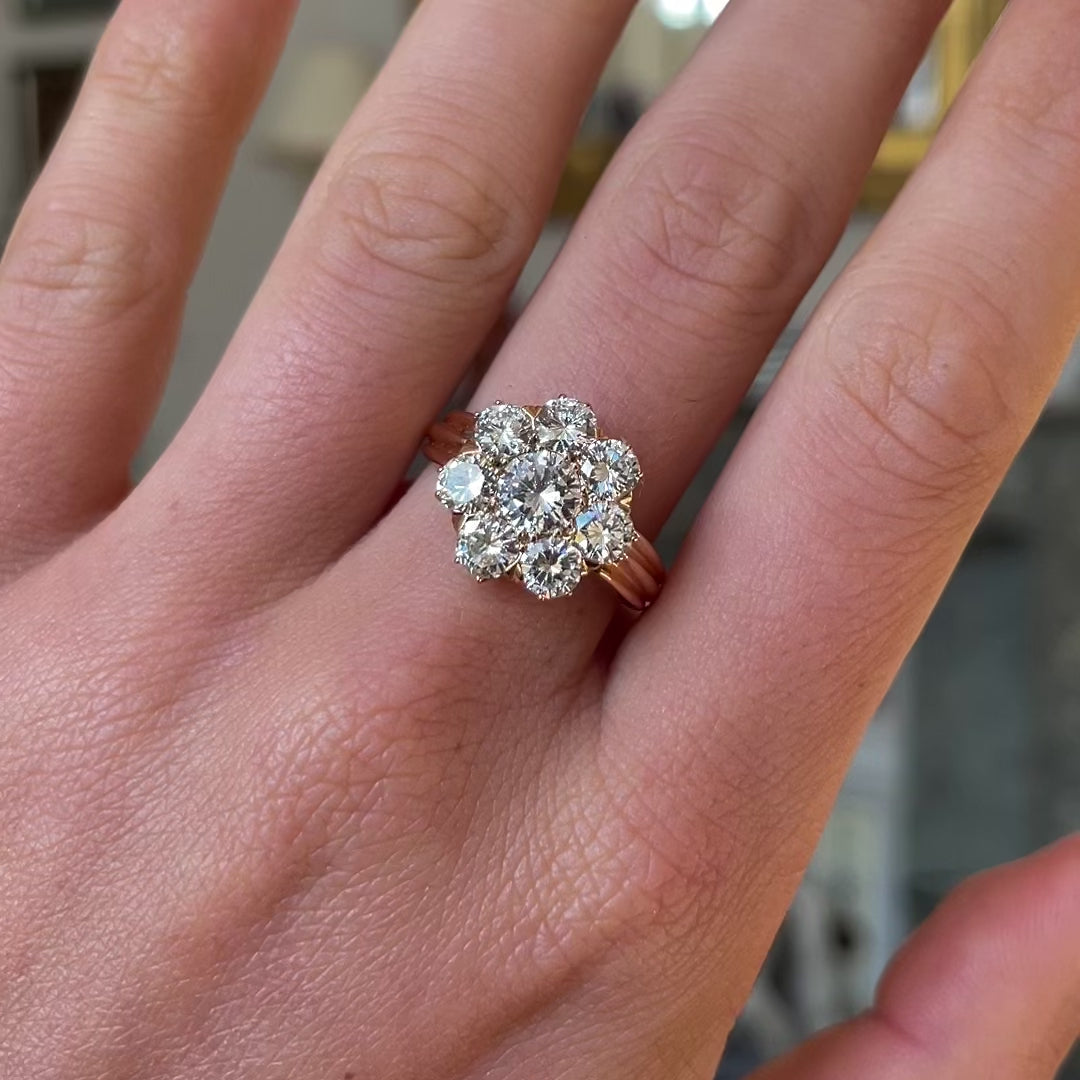 Edwardian diamond cluster engagement ring worn on hand and moved around to give perspective.