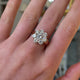 Edwardian diamond cluster engagement ring worn on hand and moved around to give perspective.