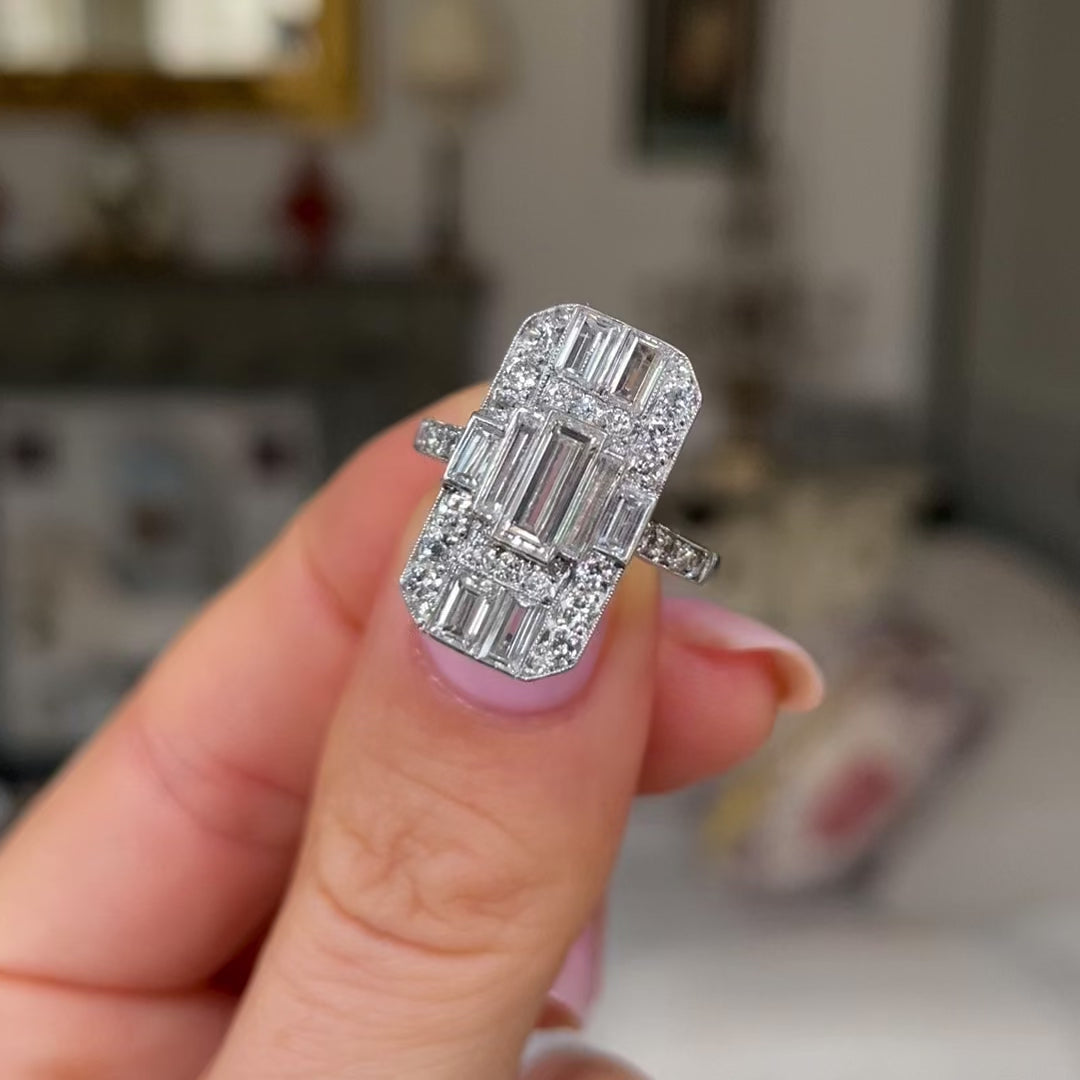 Art Deco diamond panel ring, held in fingers and rotated to give perspective.