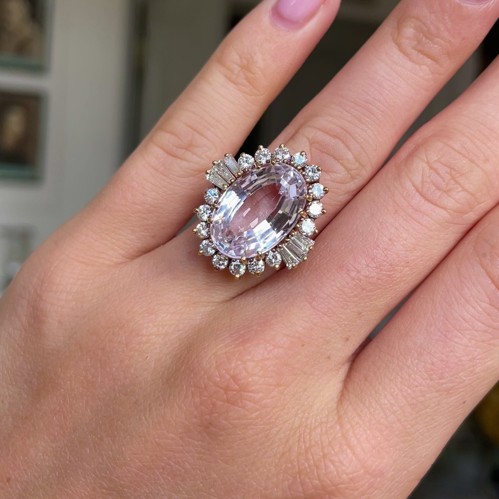 Morganite and diamond cluster cocktail ring,  worn on hand and moved around to give perspective.