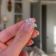 Victorian five-stone diamond engagement ring, held in fingers and rotated to give perspective.
