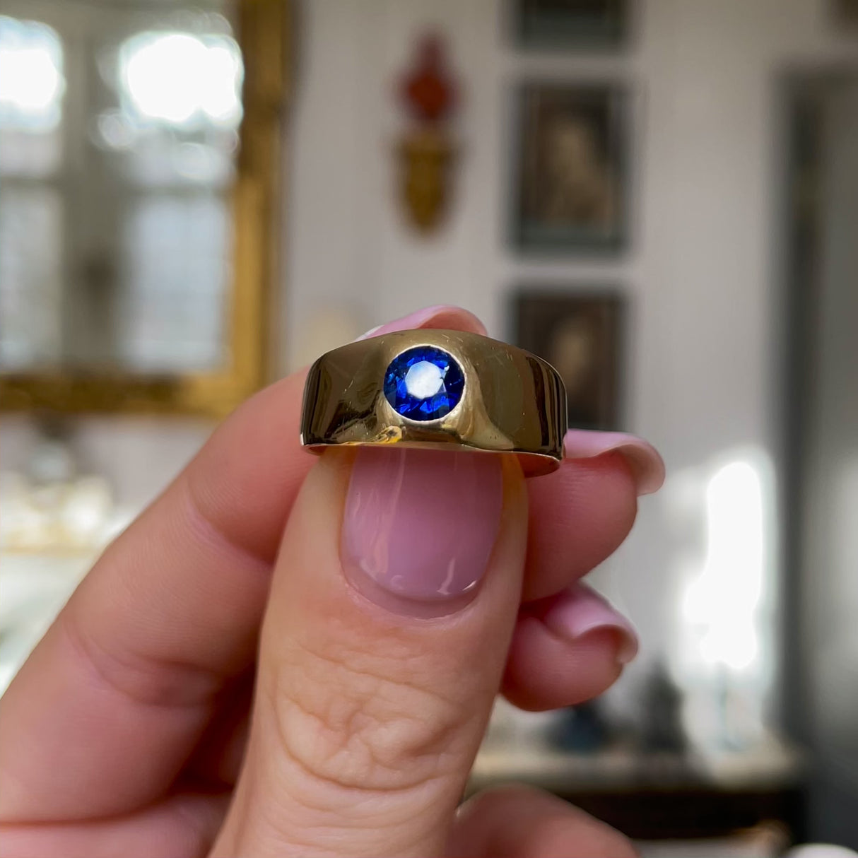 Victorian Burmese sapphire engagement ring, held ijn fingers and moved around to give perspective.