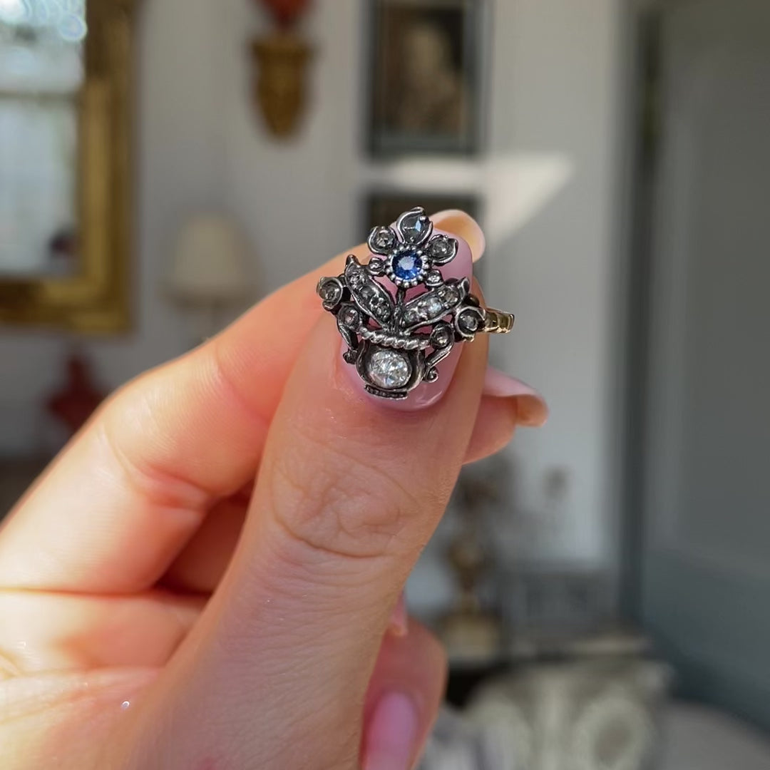 Antique Giardinetti sapphire ring, held in fingers and rotated to give perspective.