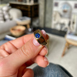 Victorian Burmese sapphire engagement ring, held in fingers.