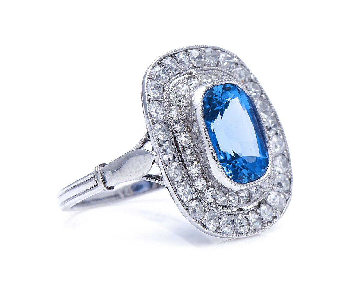 Edwardian, Platinum, Natural ‘Cornflower’ Ceylon Sapphire and Double Row Diamond Cluster Ring