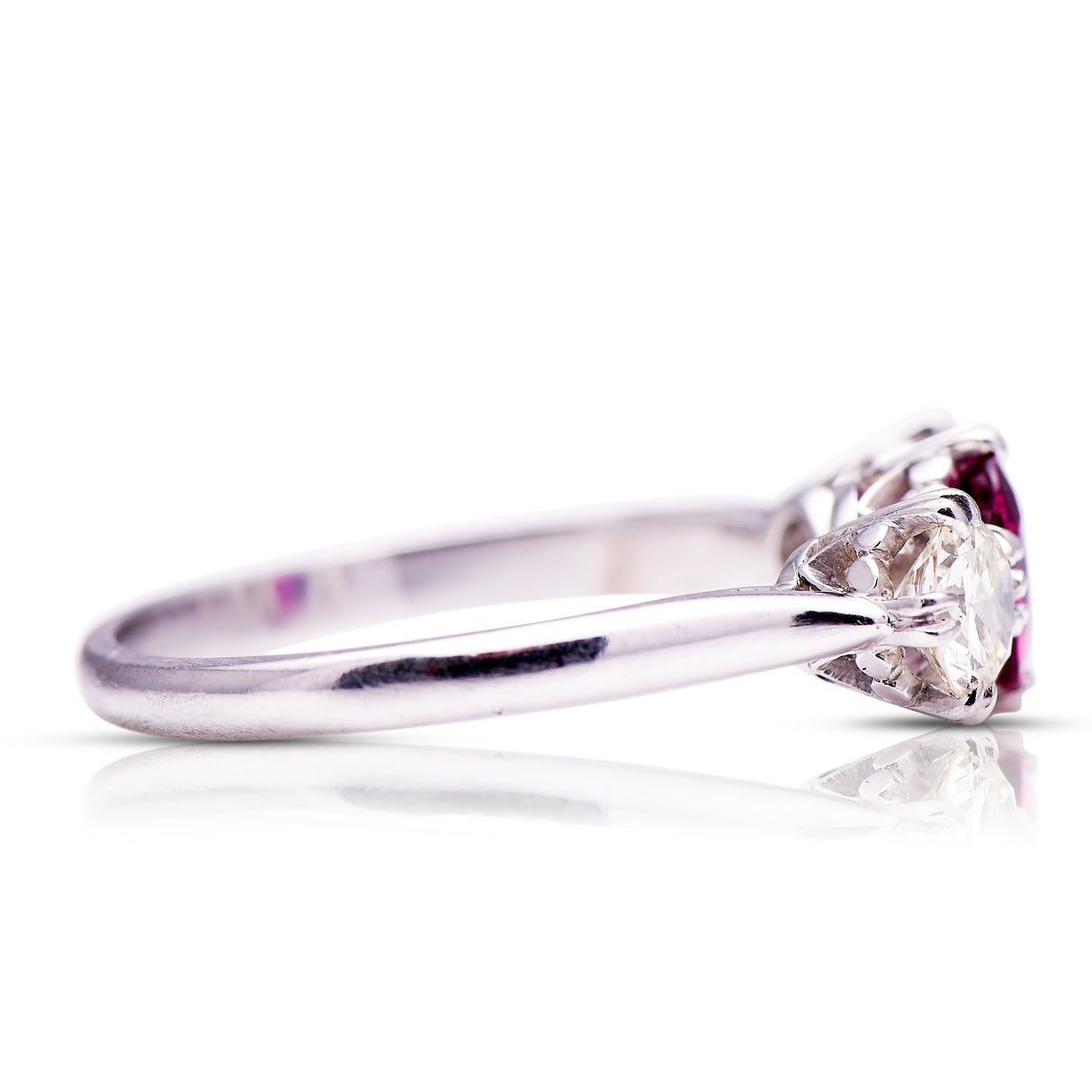 Ruby and diamond three-stone engagement ring, side view.