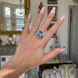 Art Deco aquamarine and diamond cluster ring, worn on hand.