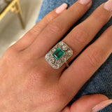 Art Deco emerald and diamond panel ring, worn on hand.