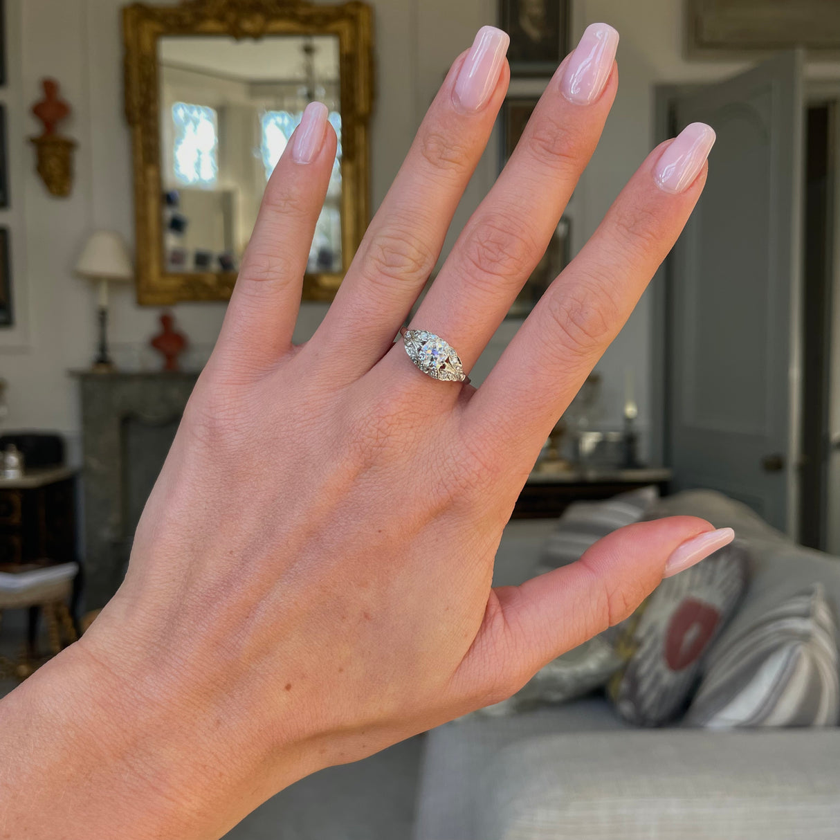 Art Deco diamond engagement ring, worn on hand.