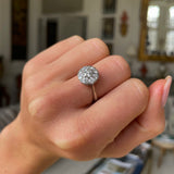 Vintage Art Deco white gold diamond cluster engagement ring, worn on hand.