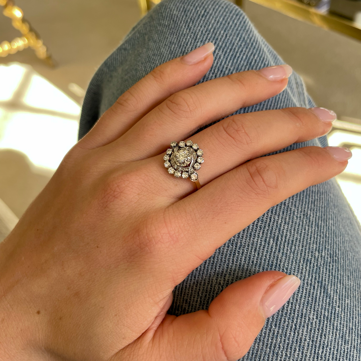 Antique French diamond cluster engagement ring, worn on hand.