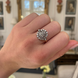 Antique French diamond cluster engagement ring, worn on hand.