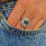 Art Deco, ceylon cushion-cut sapphire and diamond cluster ring, worn on hand.
