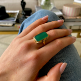 Art Deco chrysoprase and yellow gold ring, worn on hand placed on jeans.