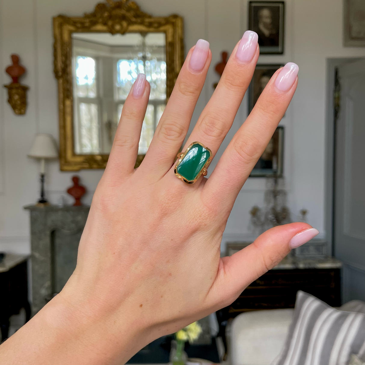 Art Deco chrysoprase and yellow gold ring, worn on hand.
