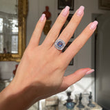 Art Deco, ceylon cushion-cut sapphire and diamond cluster ring, worn on hand.