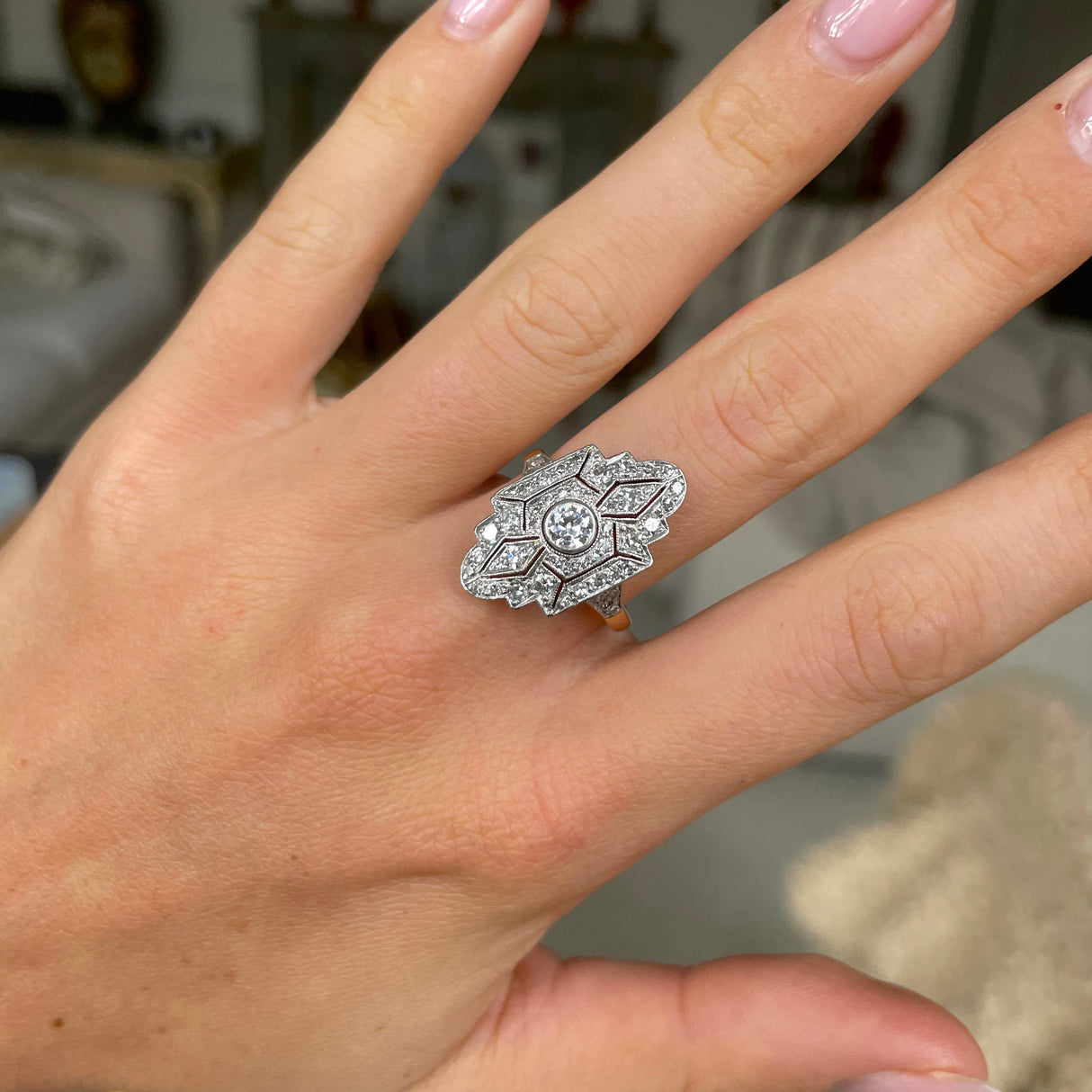 Art Deco diamond navette engagement ring, worn on hand.