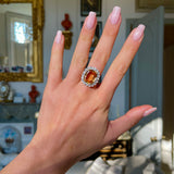 Edwardian, topaz and diamond cluster cocktail ring, worn on hand.