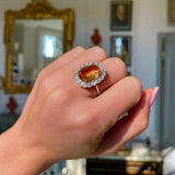 Edwardian, topaz and diamond cluster cocktail ring, worn on closed hand.