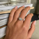 Art Deco diamond engagement ring, worn on hand.