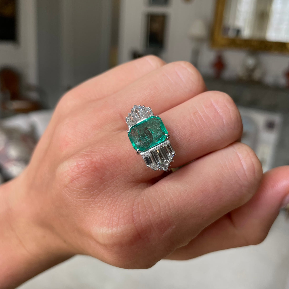 vVintage emerald and diamond engagement ring, worn on hand.
