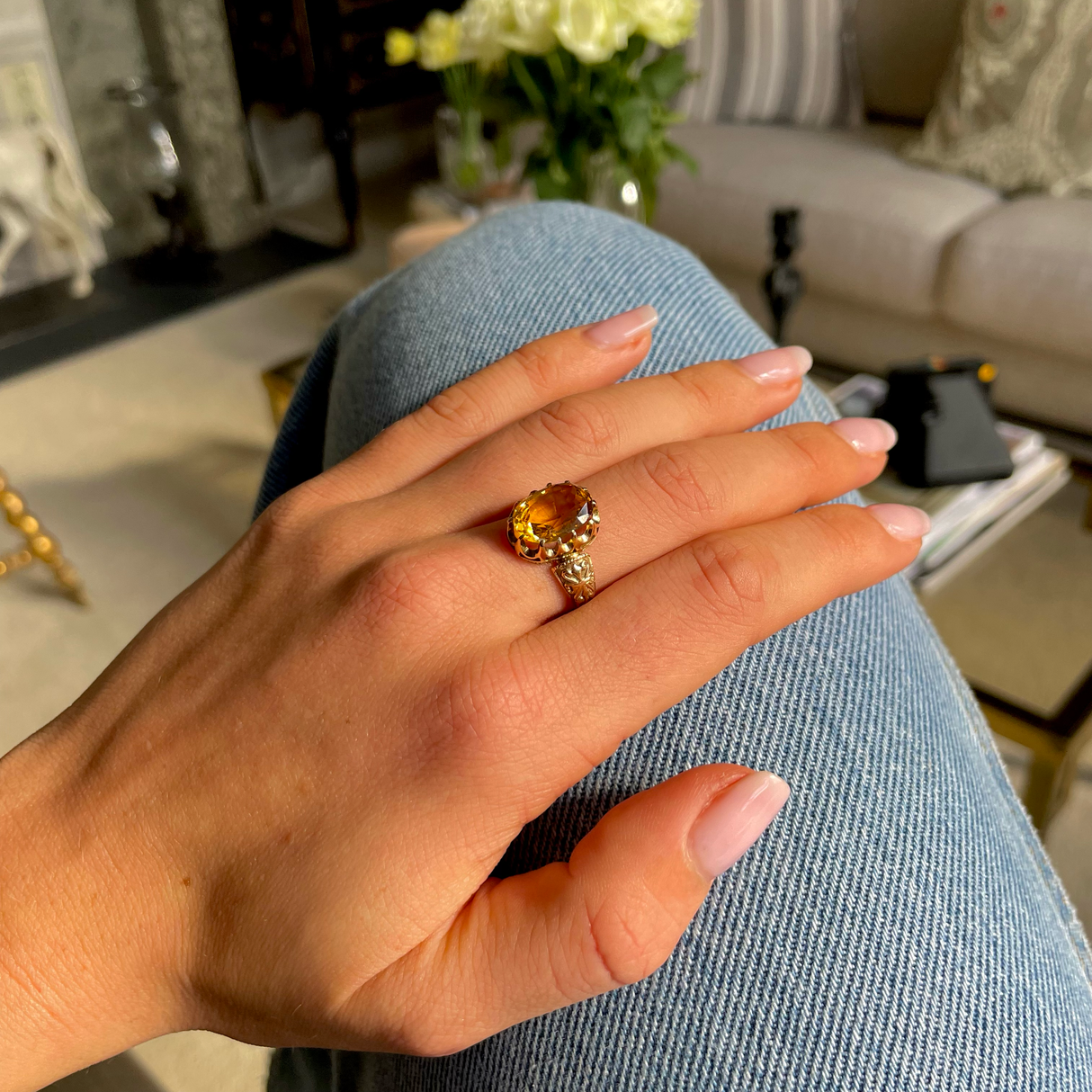 Imperial topaz single stone ring, worn on hand.