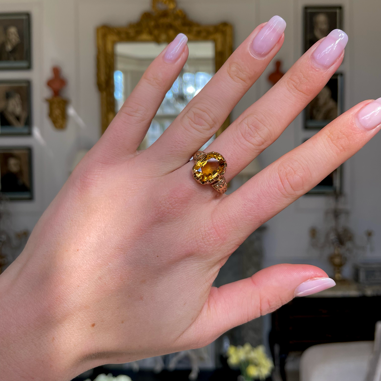 Imperial topaz single stone ring, worn on hand.