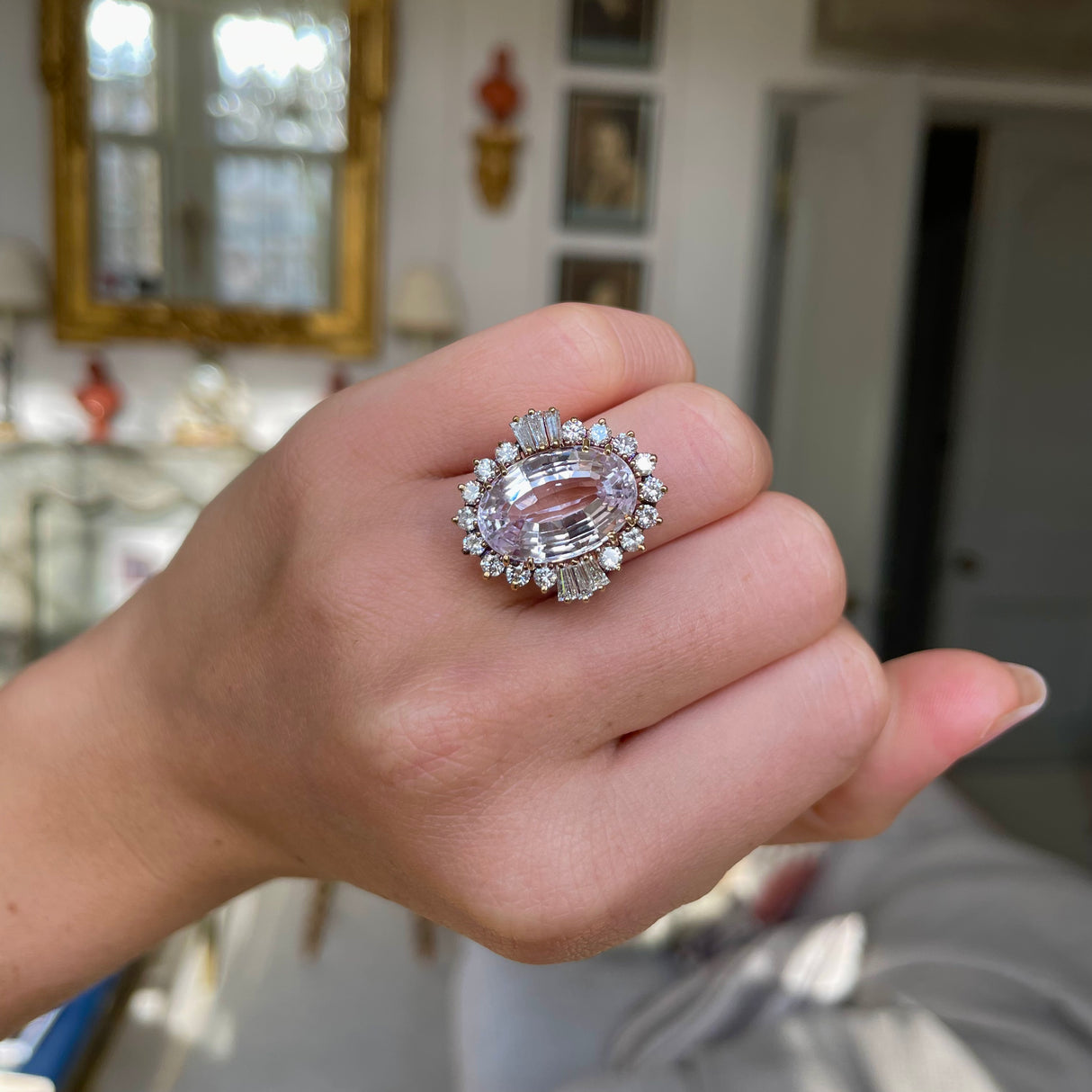 Morganite and diamond cluster cocktail ring, worn on hand.