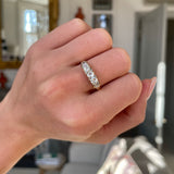 Antique five-stone diamond engagement ring, worn on hand.