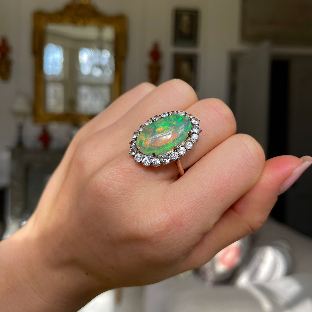 Antique opal and paste cluster ring, worn on hand.