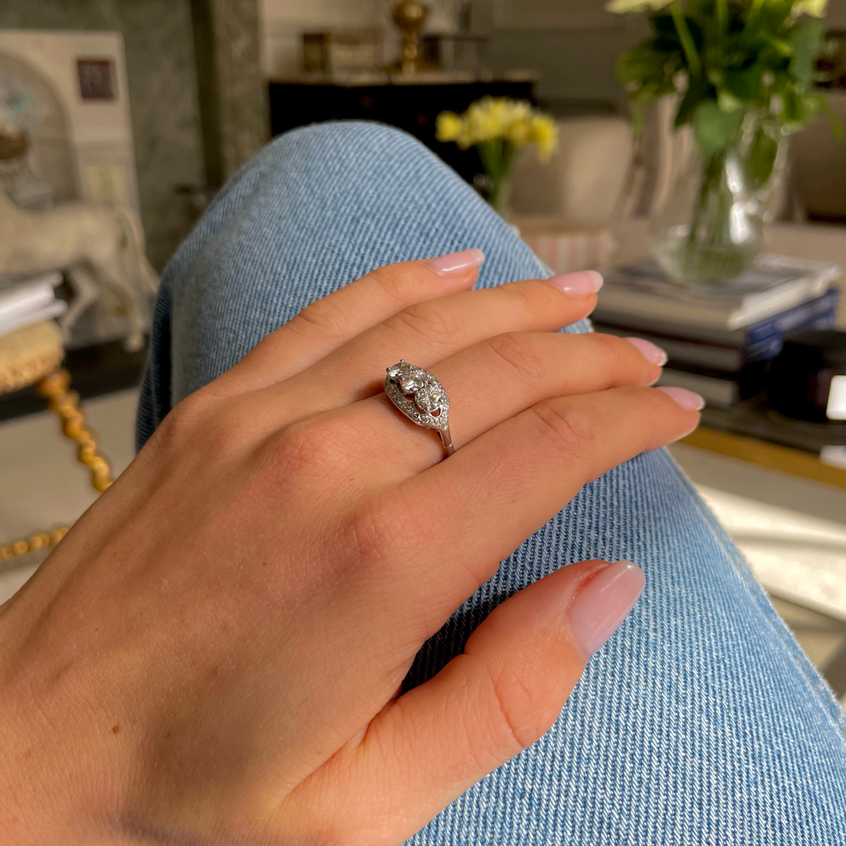 Art Deco three-stone diamond engagement ring, worn on hand