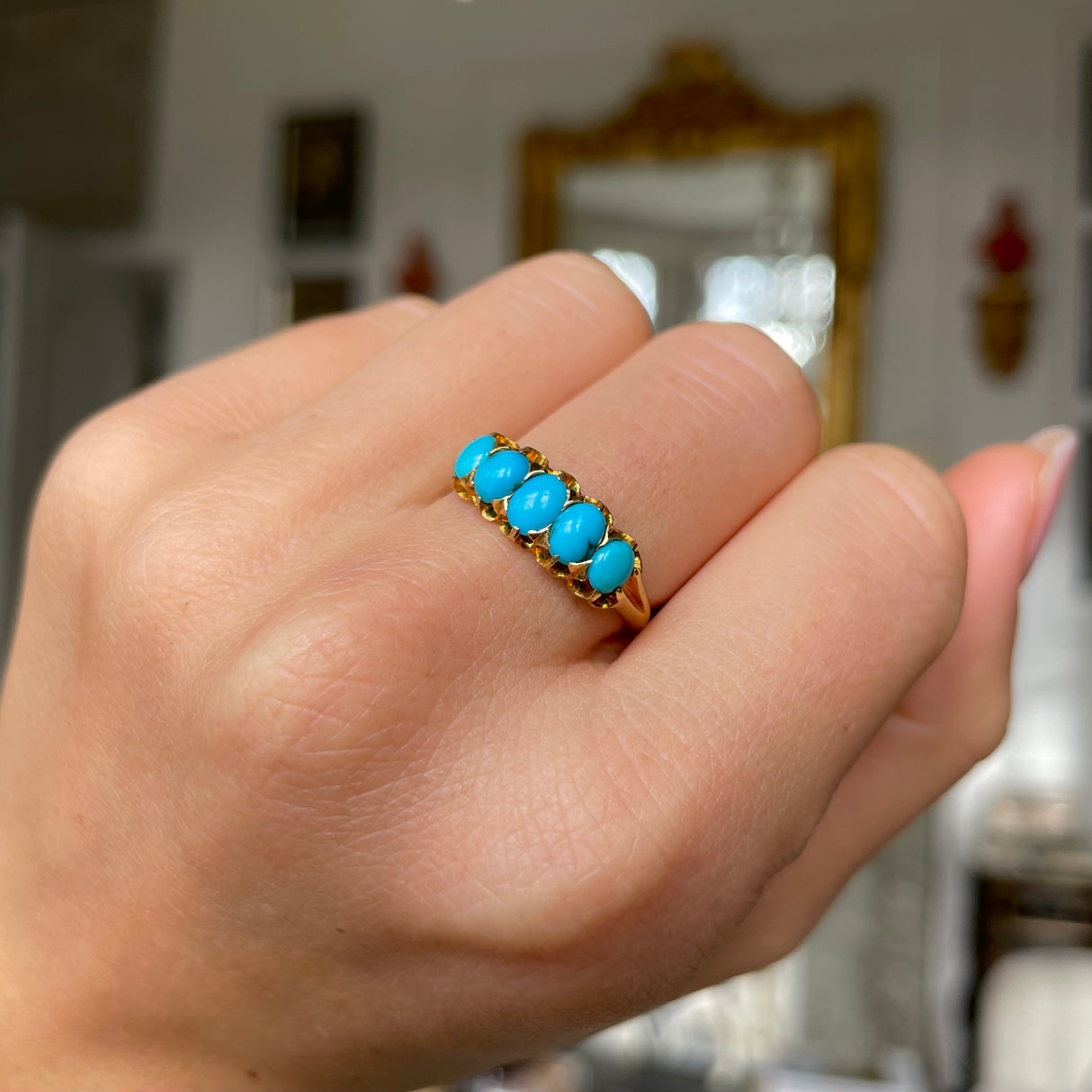 Victorian turquoise half hoop ring, worn on hand.