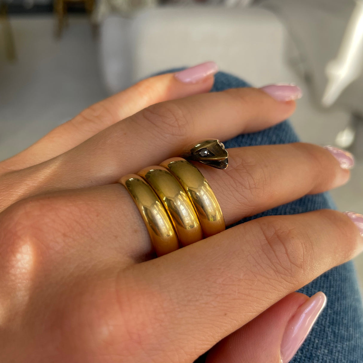 Victorian yellow gold snake ring, worn on hand.