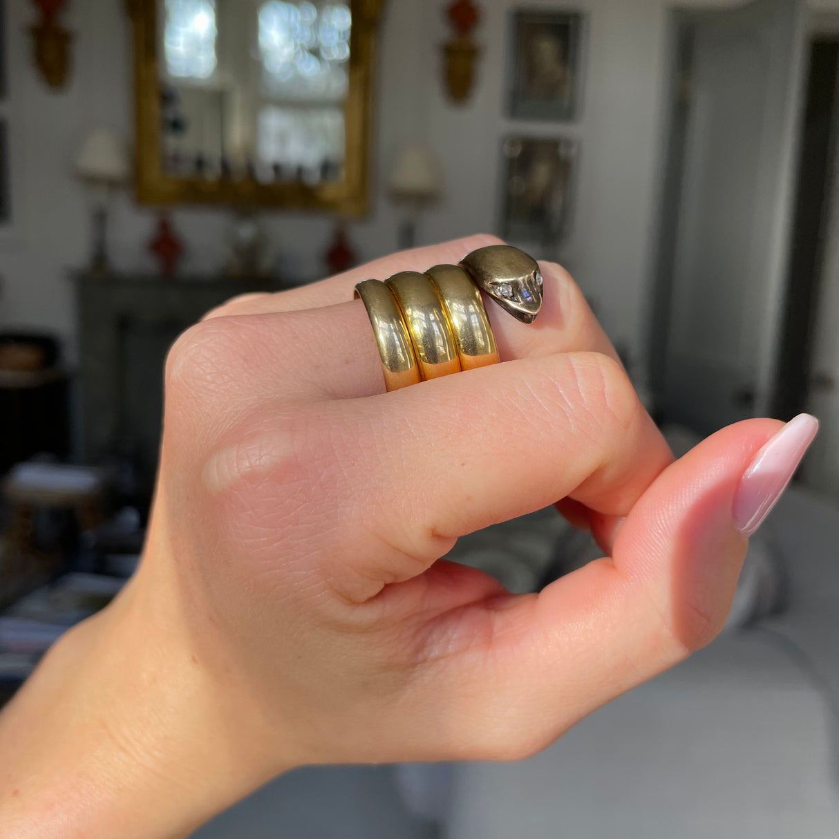 Victorian yellow gold snake ring, worn on hand. 