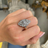 Art Deco diamond navette engagement ring, worn on hand.
