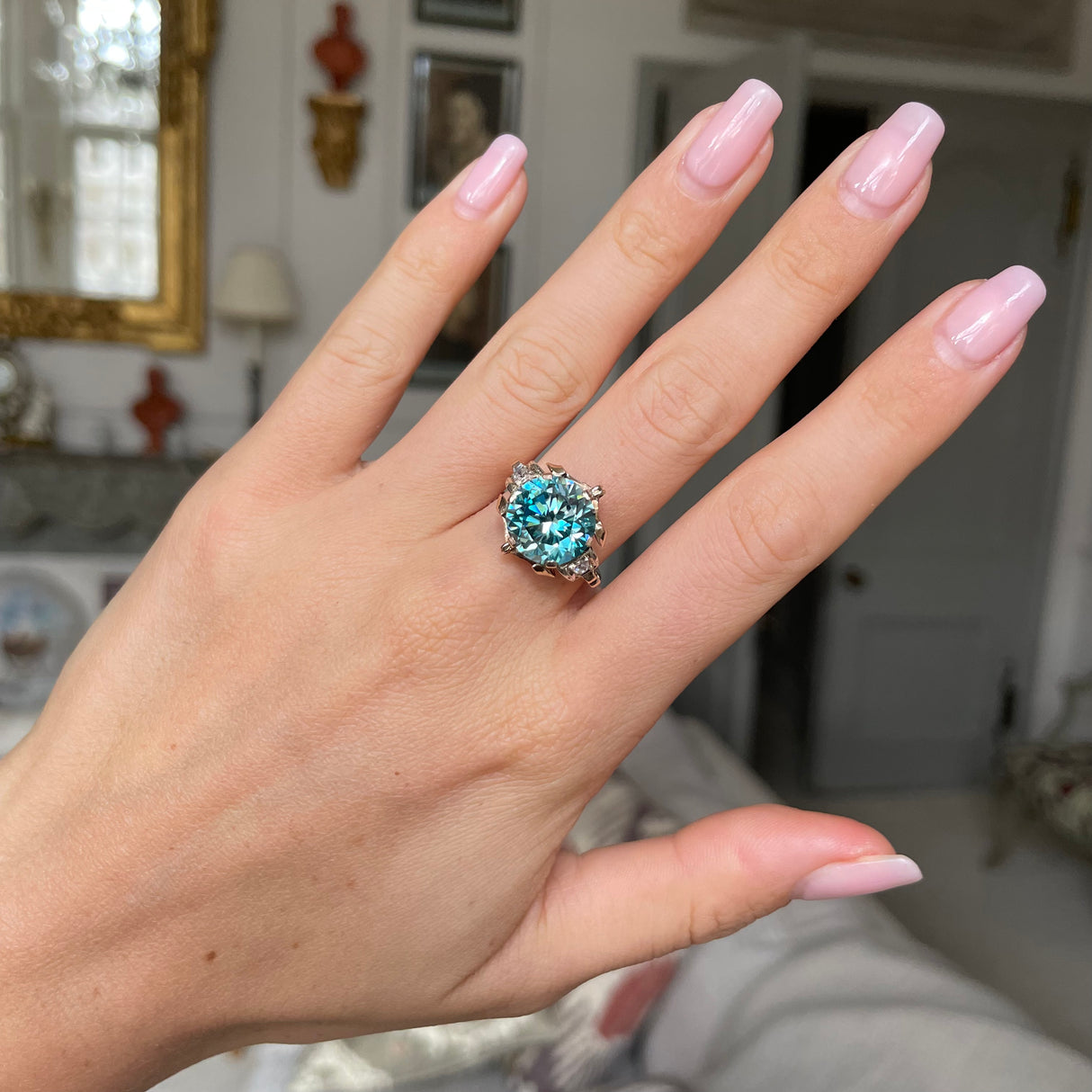 Art Deco zircon and diamond engagement ring,  worn on hand.