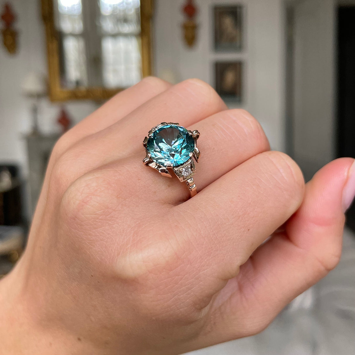 Art Deco zircon and diamond engagement ring, worn on hand.